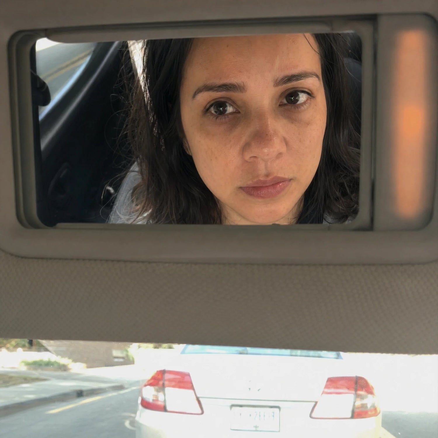 Woman noticing tired-looking skin in small moments